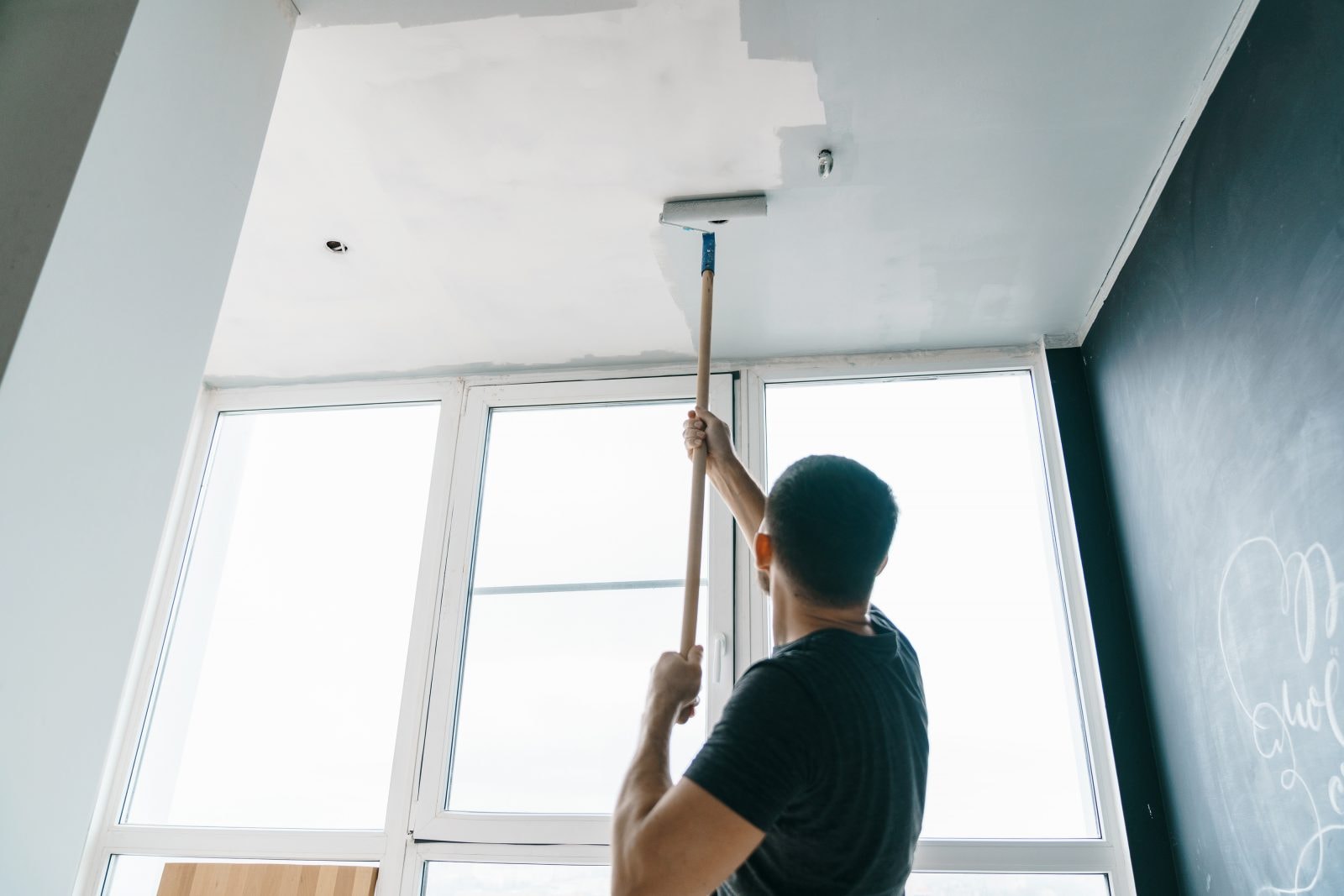 The process of ceiling painting with professional painters at work.